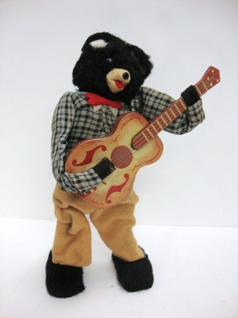 Wind-up Bear Playing Guitar: Great bear with Fir Face and Felt clothing, he is 9" high, his body sways and cranks the guitar and tail spins. He can really shake it up!