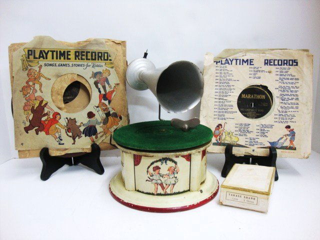 Bing Kiddy Phone Record Player: An early tinplate Kiddy Phone Junior Gramophone by Bing of West Germany - cream base, clockwork operation with turntable, with stylus needles and horn with excellent Litho of Children playing, signed