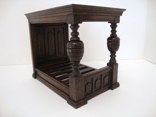 Michael Mortimer Bed: Massive Tudor Bed with headstone paneling and bulbous posts surmounted by a heavy molded canopy, by Michael Mortimer. 7" H, 8" L, 5" W.