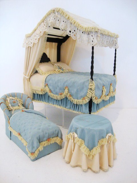 Judee Williamson Bedroom: Lovely and inviting upholstered bedroom suite by Judee Williamson comprising a stunning canopy bed with tufted bedspread and trimmed with gathered lace and tiny rosebuds, a matching chaise and a round