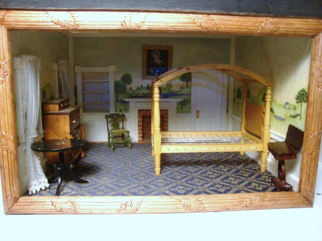 Classical Revival Roombox: Handcrafted early 19th century roombox featuring hand-painted wall murals, faux brick fireplace, built-in cupboard, delicate net curtains and furnished with an assortment of artisan furniture includin