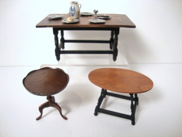 Tavern Tables: A large rustic planked tavern table 2.5" H, 5" L with a stoneware jug, five pewter plates and other accessories (some wax residue), a Warren Dick oval table with later black paint on the base, and an 