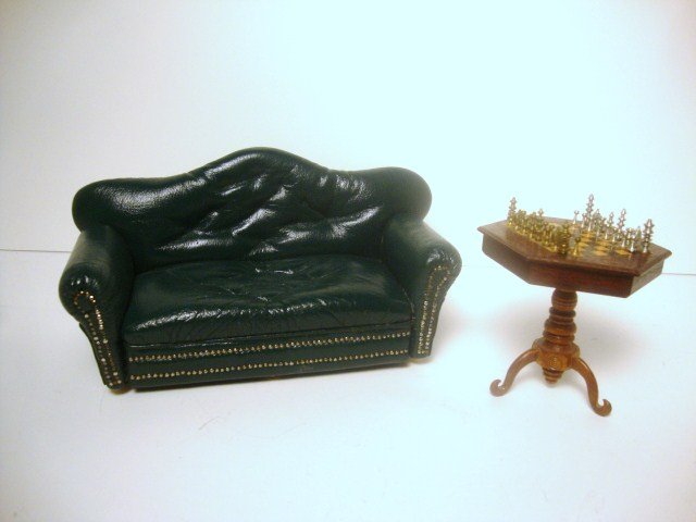 Sofa and Chess Table: A green tufted leather sofa signed by Pat Tyler 3" H, 6.5" L and an hexagonal inlaid mahogany chess table with metal chessmen by Art Russell.