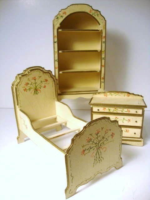 Charlotte and Hal Weston Bedroom Suite: A suite of three matching bedroom pieces comprising a single bed 4.75" H, 6" L and 3.5" W along with matching chest of drawers and open shelving unit 7" H, all sweetly handpainted with gilt trim and d