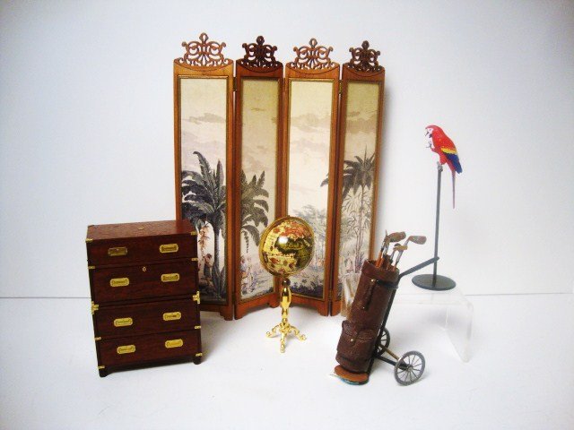 Escutcheon Stacking Chests: A pair of mahogany stacking campaign chests by Escutcheon 3.5" H, 2.5" W, a rolling bag of golf clubs, a globe on stand, a colorful painted parrot on his perch 4.25" H and a beautiful carved wooden fo