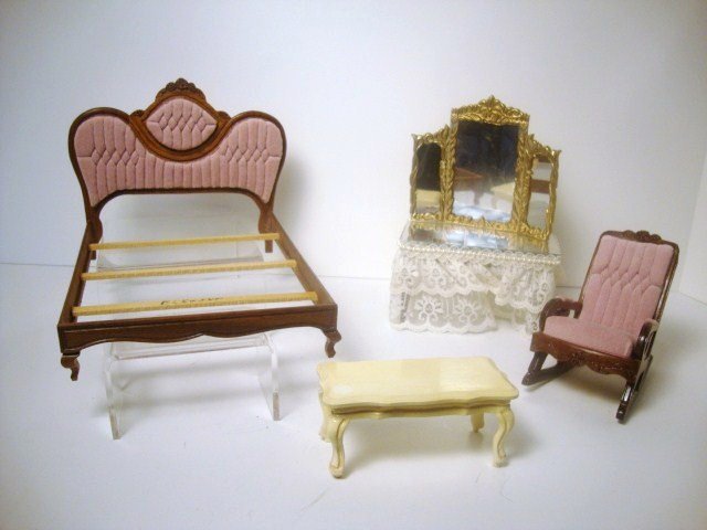 Leonetta Pink Bedroom Furniture: A carved bed with tufted headboard (reglued) 5.25" H, 7" L, 6" W, a matching rocking chair and a painted bench, all by Leonetta and a frilly dressing table with mirrored top by another artist.