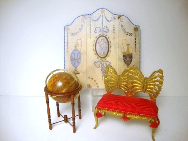 Maggie Urciuoli Globe: An Old World globe on stand by Maggie measuring just under 4" H and a striking little gilt butterfly loveseat by Nicole Walton Marble and upholstered by Judee Williamson 3.5" H and W. Also a printed f