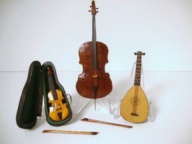 For the Musically Inclined: From the Singing Tree, a handcarved cello 4.75" H, a lute and a violin with case. One bow fits all.
