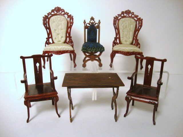 Miniature Mart II: An assortment of chairs purchased from the Miniature Mart comprising two belter armchairs 4" H, two mahogany Chinese chairs and an interesting painted resin Tudor table and chair set, the table with s