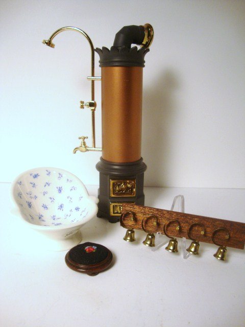 Anne Shepley Hip Bath: A pretty porcelain hip bath with blue transfer decoration 2" H, 3.5" L, a Reutter bathroom geyser 7" H, a set of servant's bells and a needlepoint footstool, the last two items from the Singing Tree.