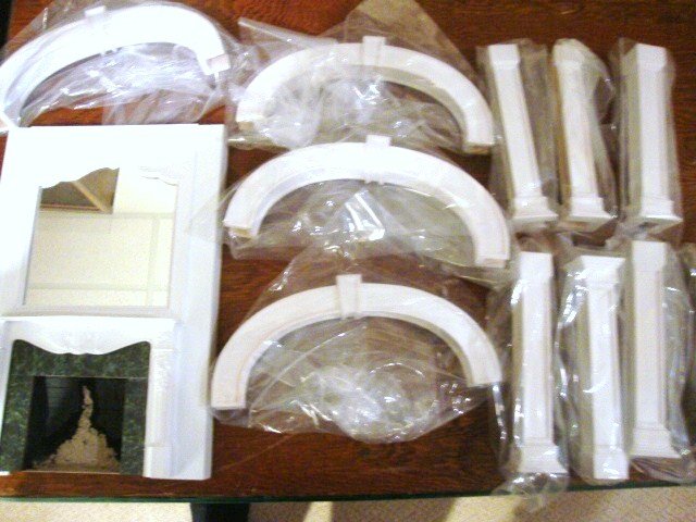 Architectural Fireplace and Doorway Trim: From the same maker as the previous lot, a fireplace with mirrored chimney breast same size as previous and four sets of arched doorway trim with cutting template. Doorways 9" H, 6.75" W.