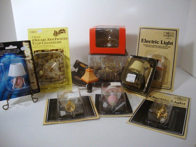 Dollhouse Lighting: Selection of ten dollhouse light fixtures in original packaging including items made by Houseworks, Cir-kit, Miniature House, etc. Twelve-arm chandeliers are the largest and measure 8" x 7" x 4".