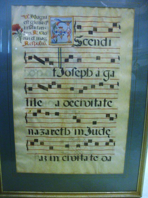 ILLUMINATED ANTIPHONY SHEET ON VELLUM: Framed Illuminated sheet music on vellum 28 1/2 x 19 3/4 sight, 37 1/2 x 27 1/2 overall. Wonderful illuminated first letter. Sheet 16th century or earlier.