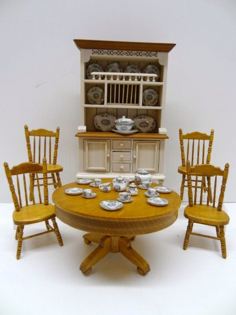 Bob Stevenson Dining Set: An artisan casual dining set comprising a round pedestal table with four matching chairs, a commercial Welsh dresser of nice quality 6.75" H, 4.5" W, and a Bespaq dinnerware set.