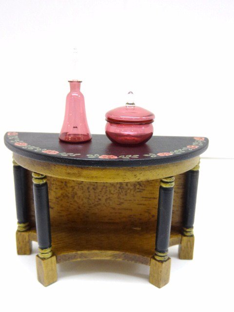 Francis Whittemore Cranberry Glass: A blown glass decanter 1" H and a covered bowl by Frank Whittemore with a painted Empire console table signed with Beth Bergman's initials bjb '95 2.5" H, 3.5" L.