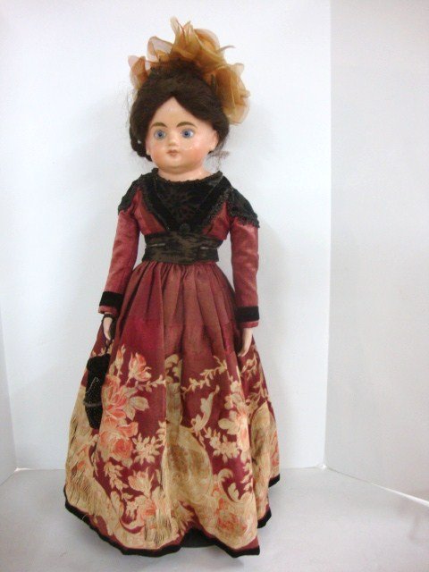 Wax over Papier Mache Doll: 28" wax over papier mache doll with blown glass eyes , fanciful vintage clothing, old wig, beautiful complexion, china arms and legs