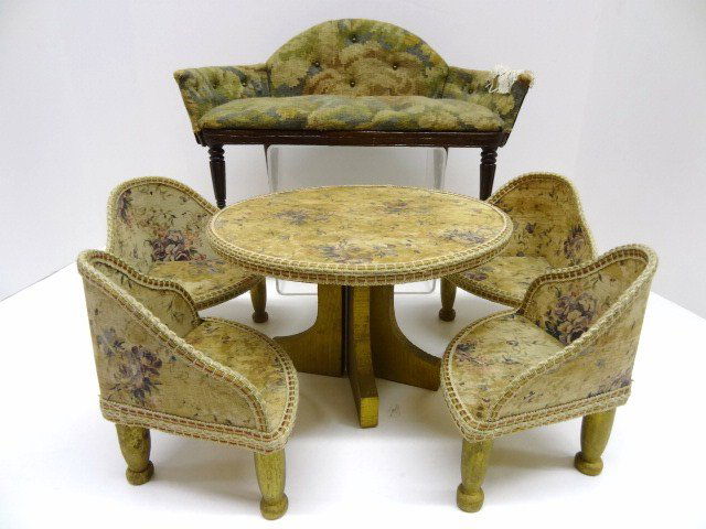 Vintage Upholstered Doll Furniture: Evocative vintage fabrics cover a five piece dining set with chairs 5.5" H and a table 8" diameter. Old glue stains. Also a vintage settee with great carved Sheraton legs 7" H, 12" L.