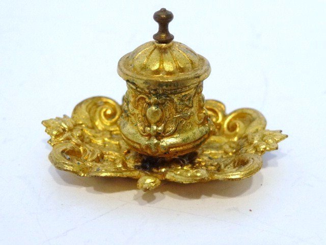 Antique Ormolu Inkstand: Charming and rare ormolu inkstand with hinged lid and affixed to an elaborately molded base. 1.25" H, 1.75" W.