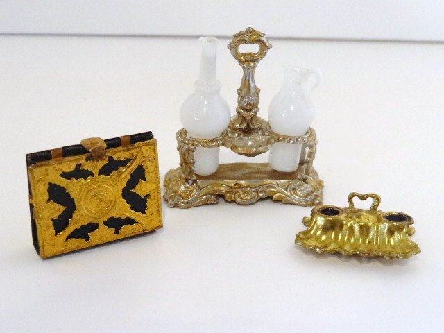 Antique Ormolu Photo Album: An antique album partially filled with photographs and boasting an ormolu fretwork cover 1.25" H, 1" W, and ormolu double inkwell (missing glass inkpots) and a gilt metal cruet with milk glass oil and