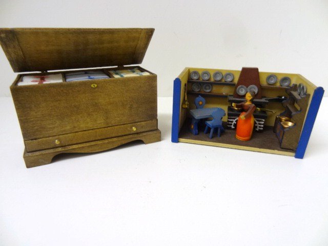 Rosemarie Torre Blanket Chest and Toy Kitchen: Colonial stained wooden blanket chest 2" H, 3.5" W, 1.75" D, packed with neatly tied linens (very slight staining), with a similarly sized delightful little Nuremburg kitchen (unsigned) featuring clev