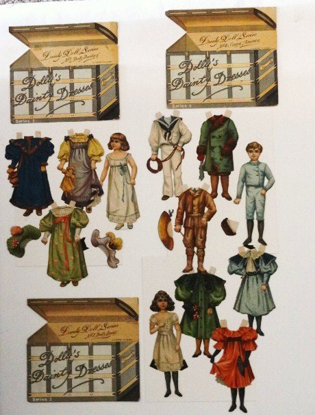 Raphael Tuck Dainty Doll Series: Vintage paper dolls: Raphael Tuck Dainty Doll Series. #1 Dolly Darling 6.5" withj three dresses anbd two hats (repair on blue dress & new back stand on doll with pocket); #3 Dolly Daisy with three dre