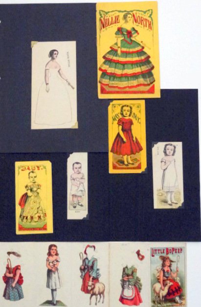 Four Uncut McLoughlin Paper Dolls: Four uncut paper dolls: Little Bo Peep; Nellie North with book of dresses; May Day; Baby.