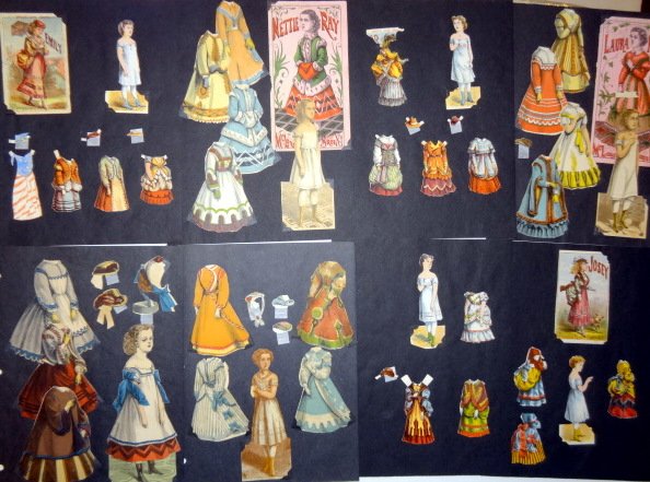 Nine McLoughlin Sets: Emily 4" with four outfits, three hats, original folder, Nettie Tay 6" with four outfits, original folder, Martha 4" four outfits, two hats, Julia 4 1/2" three dresses, one hat, Isabella 4" with three