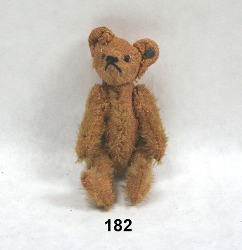 Antique Miniature Steiff Teddy Bear: Diminutive and somewhat threadbare -make that "well-loved" - a tiny 3.5" tall jointed teddy with button in ear, no tag. Missing almost all his plush on the backside, but more than compensates with muc