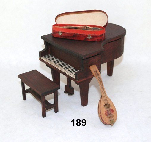 Vintage German Musical Instruments: A German red-stain grand piano and bench with music box that plays "Rosemary" from The Student Prince (key winder missing) 3.5" H, 5.5" L, 4" W, with a darling little candy container violin in case, a