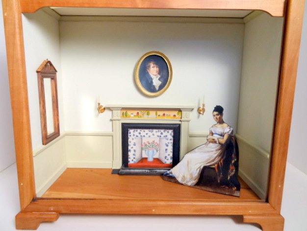 Roger Gutheil Roombox: Roombox constructed by Roger Gutheil 11.5" H, 13" W, 5.5" D, with hand-painted fireplace and fireboard by Pat Fifer under the instruction of Therese Bahl at Castine. Framed portrait and sconces glued 