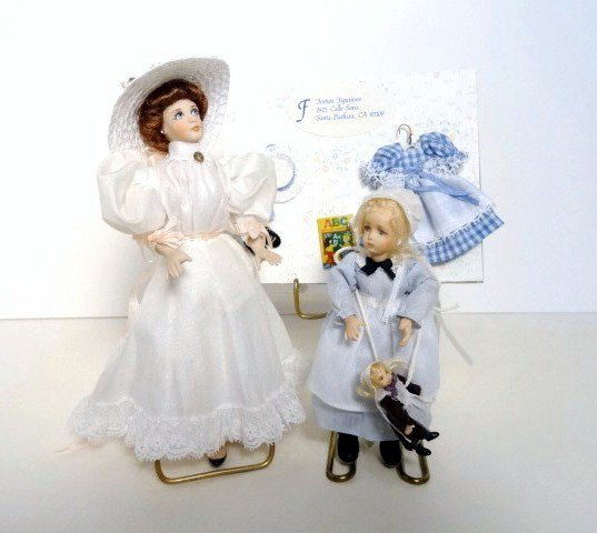 Edwardian Lady and Girl with Doll: A Fern Vasi Gibson Girl with an elegant chapeau 5.75" H and a little girl 4" H by Faith Millbrook holding her own doll. With a girl's dress on hanger.