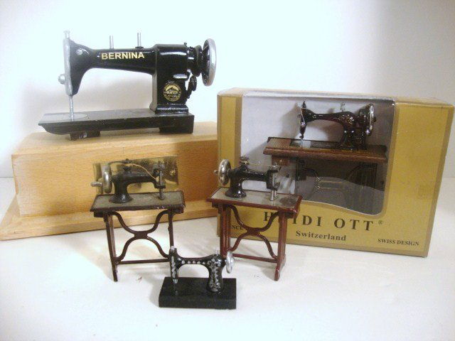 A Stitch in Time: Assortment of five miniature sewing machines ranging in size from a Bernina music box 6" H including stand to vintage 1" scale machines. Sew your heart out.