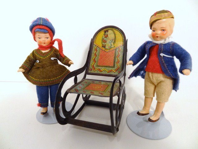 Painted Bisque Dolls and Tin Litho Rocker: Two vintage German painted bisque dolls, in original, excellent condition 4.5" H, with a tin litho rocking chair 4", in very good condition.