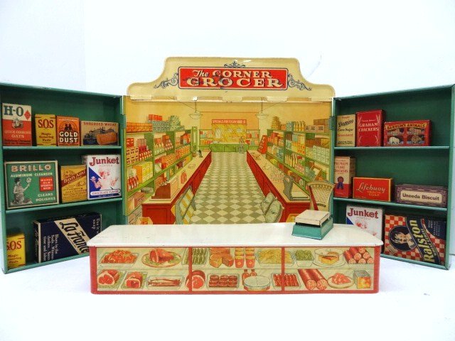 Wolverine Tin Corner Grocer: Tin Corner Grocer display by Wolverine, 31 in. (L) (outstretched), comes w/counter 16 in. (L), scale & 17 product boxes, 14 1/2 in. (H)