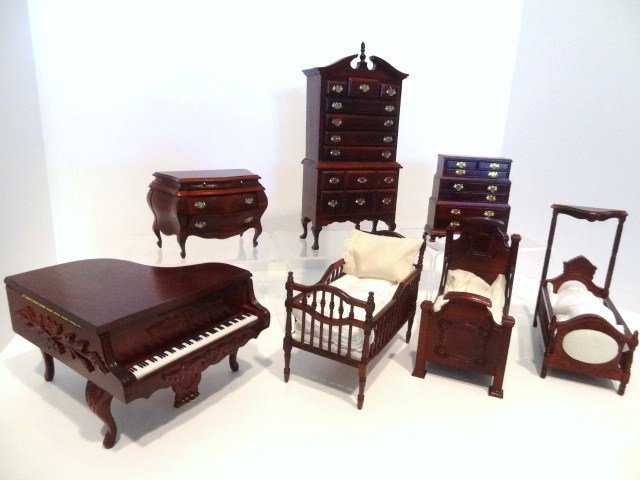 Lot of Concord Furniture: Large lot of commercial furniture made in Taiwan comprising a grand piano 4" H, 5" W and 6" L, a highboy, two chests of drawers and three children's beds. Adhesive residue on some surfaces.