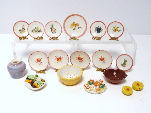 Debbie McKnight Cookies and Kitchenware: A plate of Christmas cookies 1" diameter, two colanders and a jug, an assortment of plates and two grapefruit halves with plates.