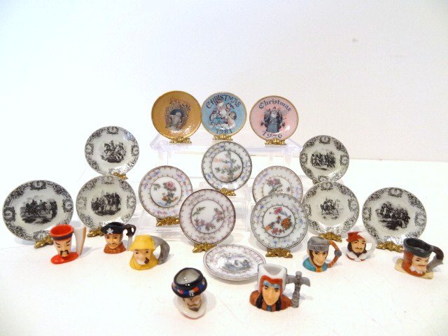 Toby Mugs and Plates: A collection of eight miniature Toby mugs signed C.P., 1/2" H, six Ellen Krucker Napoleon plates and three of her Christmas plates, plus six Bespaq porcelain plates. Wax residue.