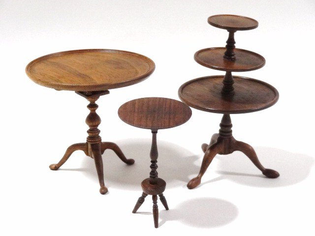 Three Tables by Edgar Callahan: A round tea table with birdcage base and raised dished rim top 2.5" H, 3" diameter, a three-tiered dumbwaiter and a small occasional table, all by Edgar Callahan.