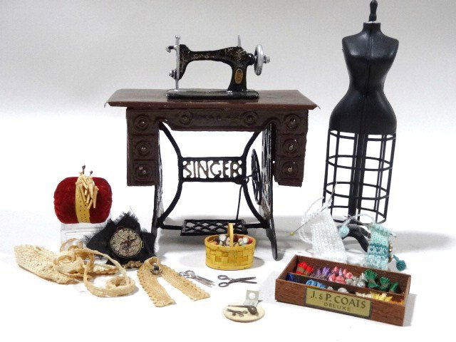Dressmaking: An assortment of sewing-related items including a tin sewing machine, plastic dressmaker's form 5" H, terrific assortment of tiny spools and skeins of thread, knitting and lace-making implements and t
