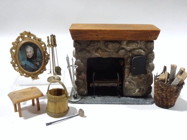 Harry Smith Stone Fireplace: From the early days of his career, a cast stone fireplace with wooden mantel and slate hearth 4" H, 4.5" W, with good assortment of tools and accessories including a perfect basket of logs, stool, and