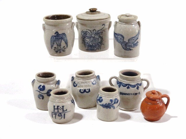 Carolyn Curran Stoneware: Nice assortment of blue decorated pantry jars with the largest 1.25" H, and a redware covered jug. 9 items.