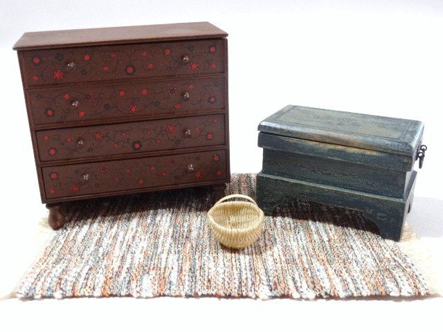 Jim Holmes Chests: An early Taunton chest with hand-painted decoration 3.5" H, 3.75" W, an aged green over black painted tool chest by the same artist, with an Al Chandronnait basket and a woven rug.
