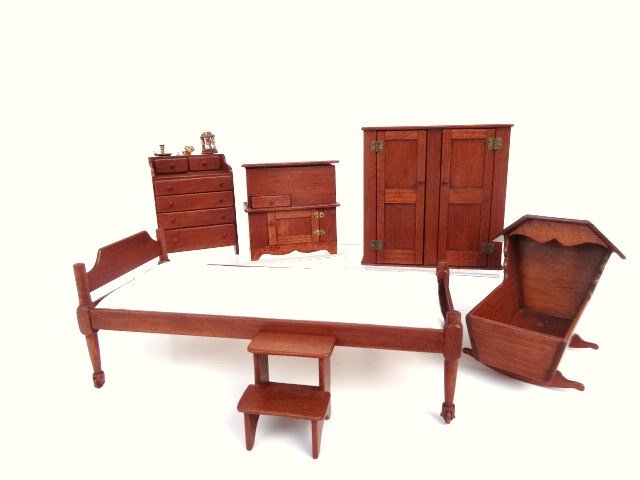 Hank Miller Shaker Bedroom Furnishings: A Shaker bed with wheels 2.5" H and W, 6" L, a cradle, steps, washstand, two-drawer cupboard and a charming little work table with thread holder and tape measure. Sweet.