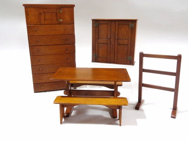 Hank Miller Shaker Cupboards and Table: An assortment of nicely finished Shaker furniture comprising a tall cupboard with seven drawers 6.75" H, 4" W, smaller two-door cupboard, a trestle table with two benches and a towel stand.