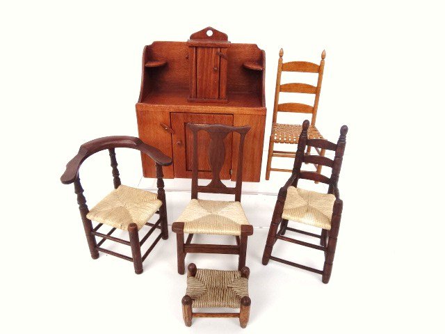 George Hoffman Chairs: Three chairs from the Sturbridge Village Collection including a high chair 3.5" H, corner chair, country splat-back chair, classic wash stand and hanging cupboard. Also a varnished ladder-back chair w