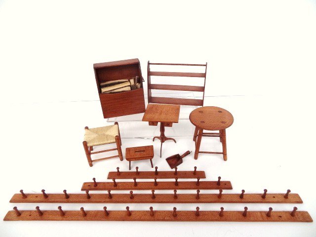 George Hoffman Shaker Furniture: Nice assortment of classic Shaker furnishings including classic woodbox 3" H, 2.5" W, hanging shelf, footstool with woven seat, sewing stand, small step stool, country table, and four pegboards of var
