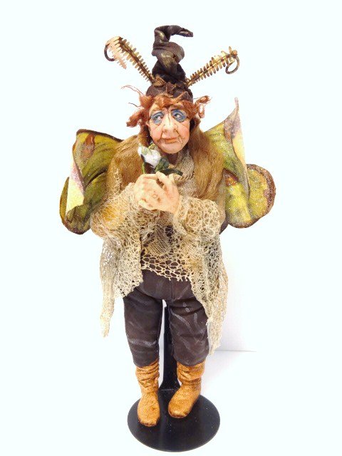 Marcia Backstrom Fantasy Figure: Hmmm. It's not every day you see an older fellow dressed up as a butterfly, is it? Trick or treat? 6" H plus hat.
