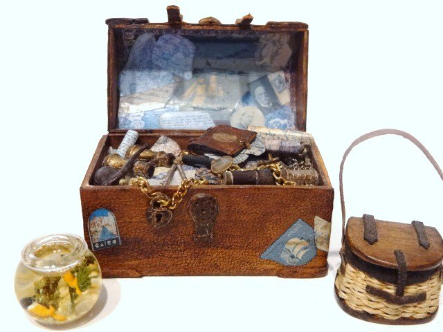 Sea Captain's Chest: Incredibly detailed leather trunk filled with nautical charts, spyglasses, captain's log, etc., made by P. Bolton 1996. Also a fishing creel and a goldfish bowl.