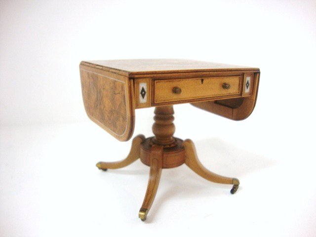 John Stevens Pembroke Table: Outstanding George IV drop-leaf table with pedestal base, burled walnut veneered panels and fine inlay work, brass casters, delicate string work, the drawer has a lock and key, very fine. Dated 1979 f
