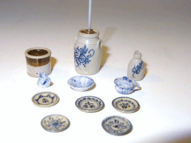 Jane Graeber Half-scale Stoneware: Nice assortment of Jane Graber decorated stoneware including a butter churn under 1" H, jug and set of five assorted plates. Also tiny spongeware chamber pot, pitcher and bowl signed SD and a crock by